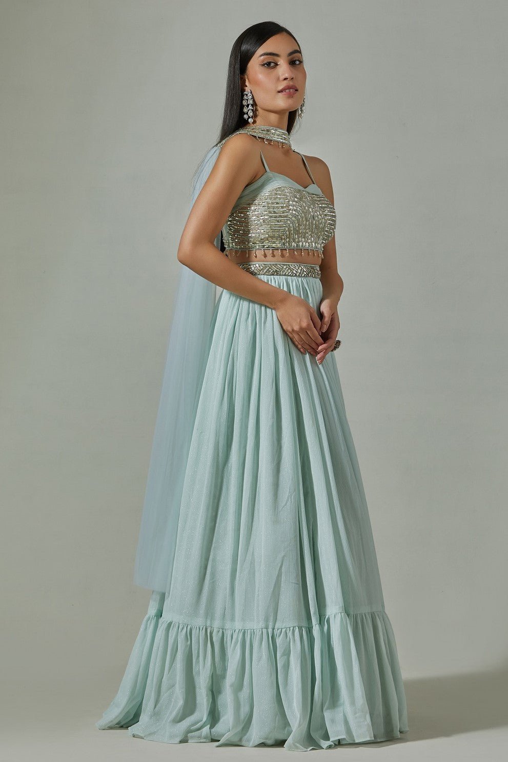 Buy beautiful sky blue georgette lehenga online in USA with embroidered sequin blouse. Dazzle on weddings and special occasions with exquisite Indian designer dresses, sharara suits, Anarkali suits, wedding lehengas from Pure Elegance Indian fashion store in USA.-side