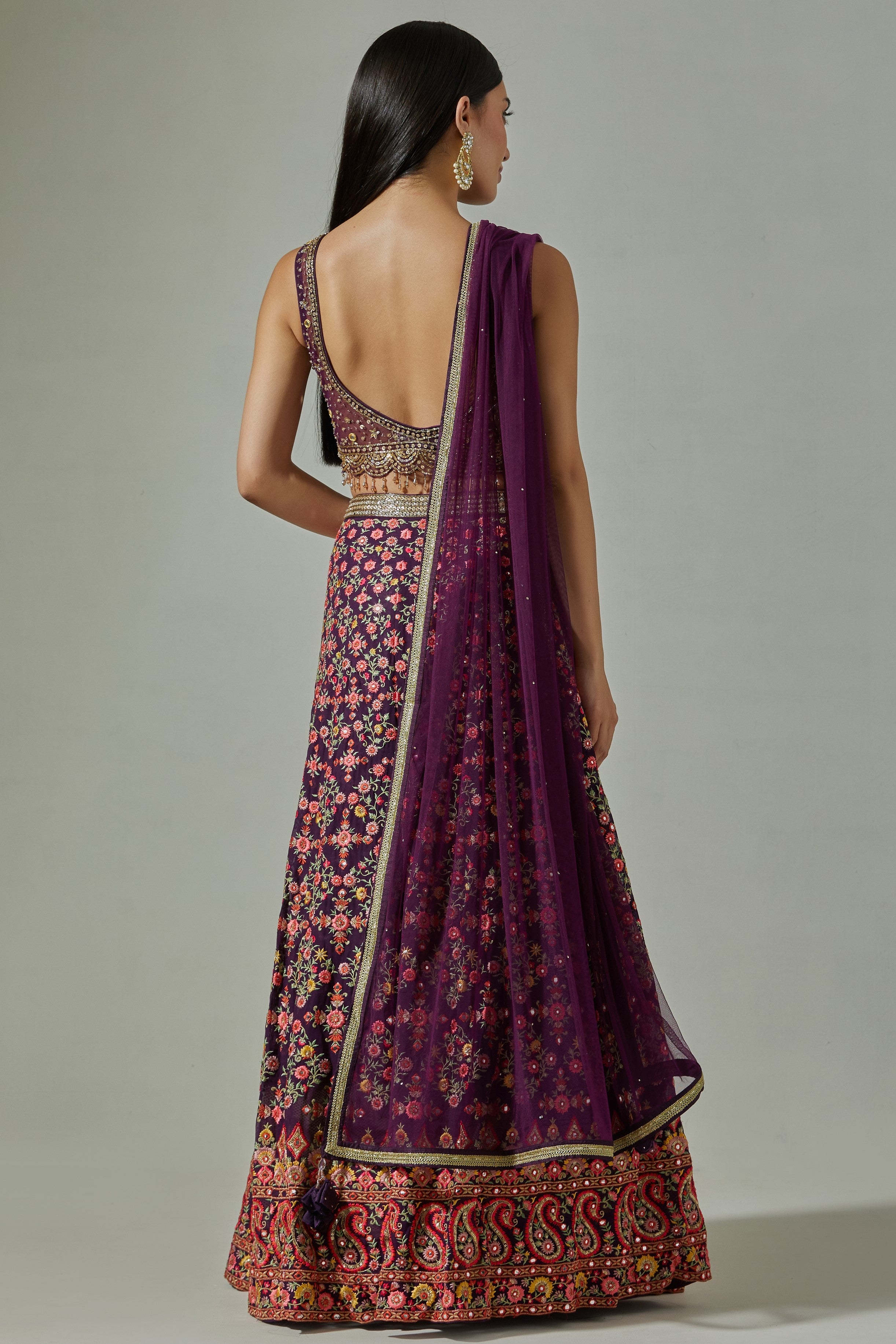 Buy beautiful purple heavy embroidery lehenga online in USA with soft net dupatta. Dazzle on weddings and special occasions with exquisite Indian designer dresses, sharara suits, Anarkali suits, wedding lehengas from Pure Elegance Indian fashion store in USA.-back
