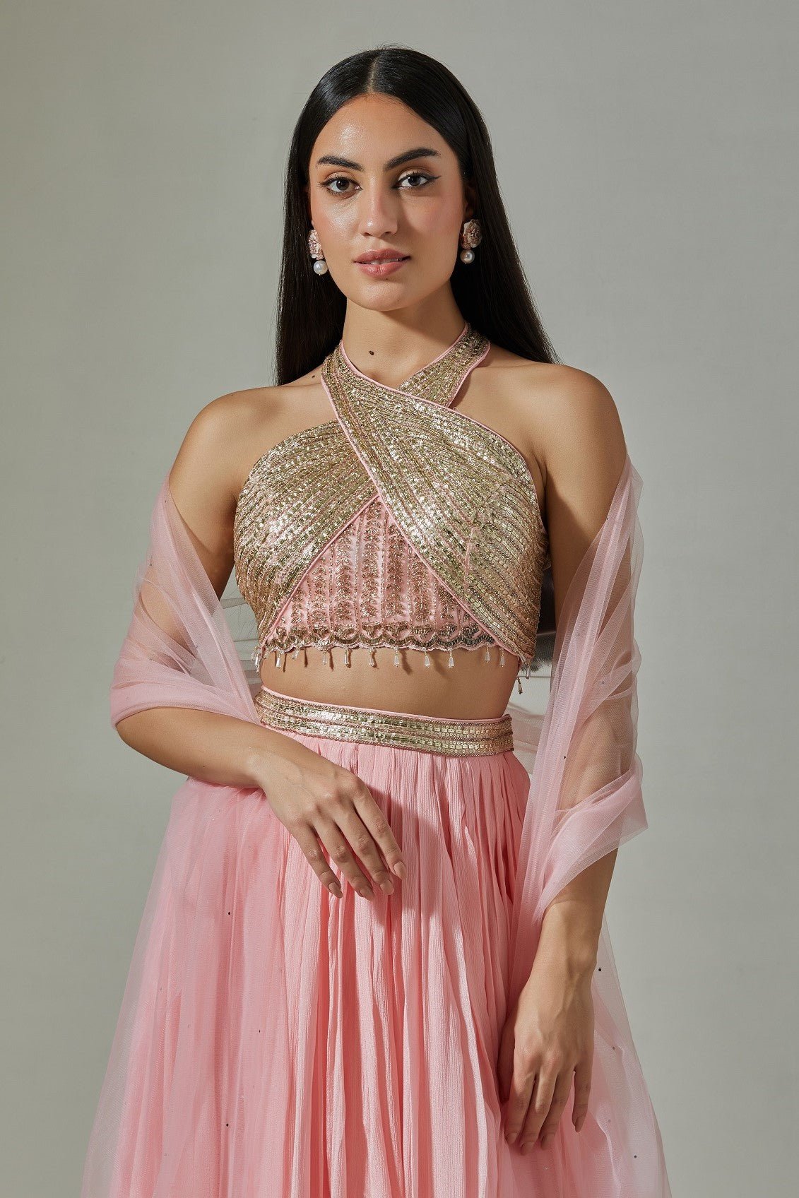 Shop beautiful baby pink cross halter chinon lehenga online in USA with pearl and mirror work. Dazzle on weddings and special occasions with exquisite Indian designer dresses, sharara suits, Anarkali suits, wedding lehengas from Pure Elegance Indian fashion store in USA.-closeup