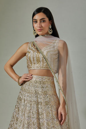 Shop beautiful beige embroidered lehenga online in USA with pale pink dupatta. Dazzle on weddings and special occasions with exquisite Indian designer dresses, sharara suits, Anarkali suits, wedding lehengas from Pure Elegance Indian fashion store in USA.-closeup