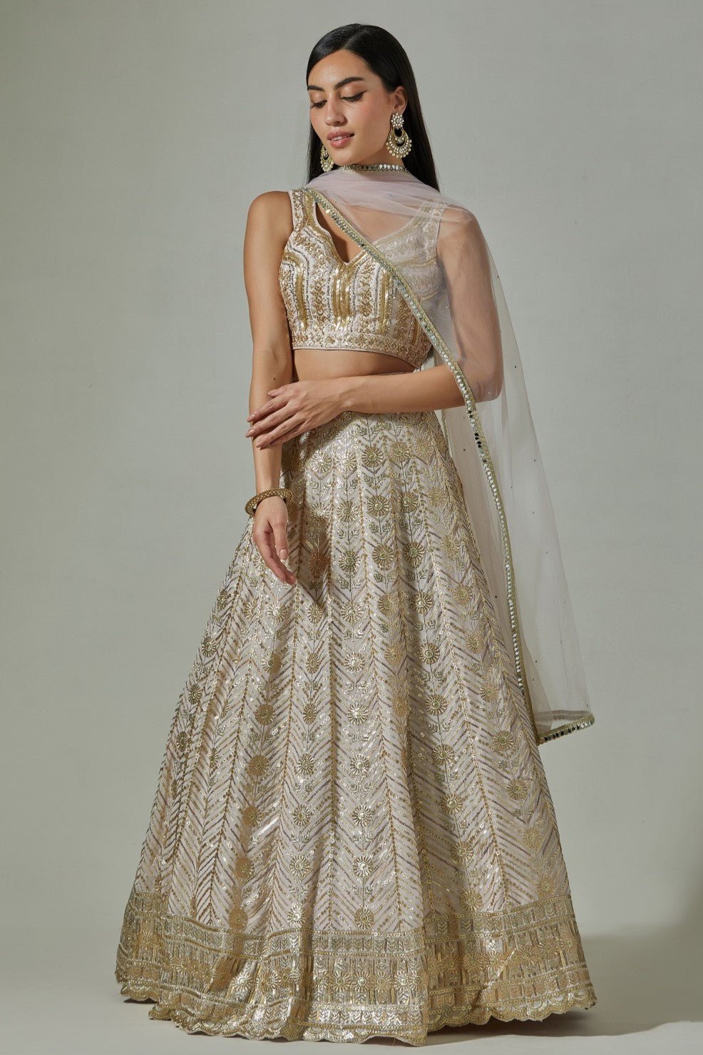 Shop beautiful beige embroidered lehenga online in USA with pale pink dupatta. Dazzle on weddings and special occasions with exquisite Indian designer dresses, sharara suits, Anarkali suits, wedding lehengas from Pure Elegance Indian fashion store in USA.-front