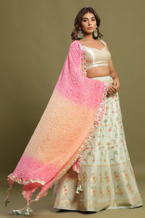 Shop a Beautiful light blue silk lehenga with a multicolor dupatta. The lehenga is perfect for weddings and sangeet parties. It is crafted in silk with intrinsic floral self-design work, tassels, and a beautiful off-white blouse. Shop online from Pure Elegance.