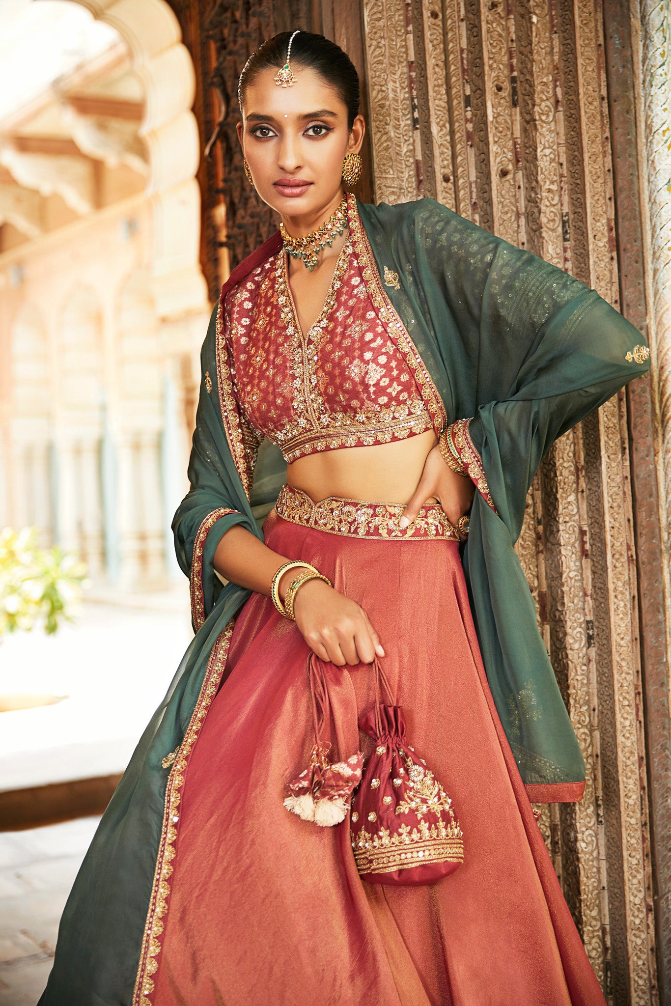Gorgeous rust color embroidered tissue lehenga with dupatta is a perfect choice for a sangeet and engagement parties. The lehenga is adorned with beautiful embroidery and a contrasting dupatta. Shop designer Indian lehengas in USA from Pure Elegance.