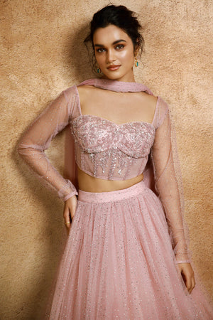 Shop your best on wedding occasions in this stunning hand-embroidered sequins, stones & cut dana pink lehenga. The lehenga comes with a soft net dupatta. Dazzle on weddings and special occasions with exquisite Indian designer dresses, sharara suits, Anarkali suits, bridal lehengas, and sharara suits from Pure Elegance Indian clothing store in USA.