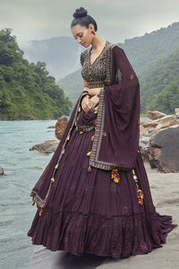 Shop this beautiful wine lehenga with floral embroidery choli and georgette dupatta with tassels. The lehenga is perfect for a wedding night. Shop online from Pure Elegance.