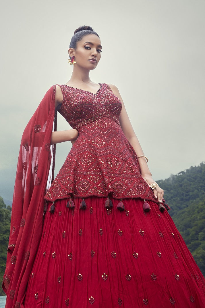 Shop this beautiful red lehenga with embroidered peplum choli. The lehenga is perfect for weddings and sangeet parties. Shop online from Pure Elegance