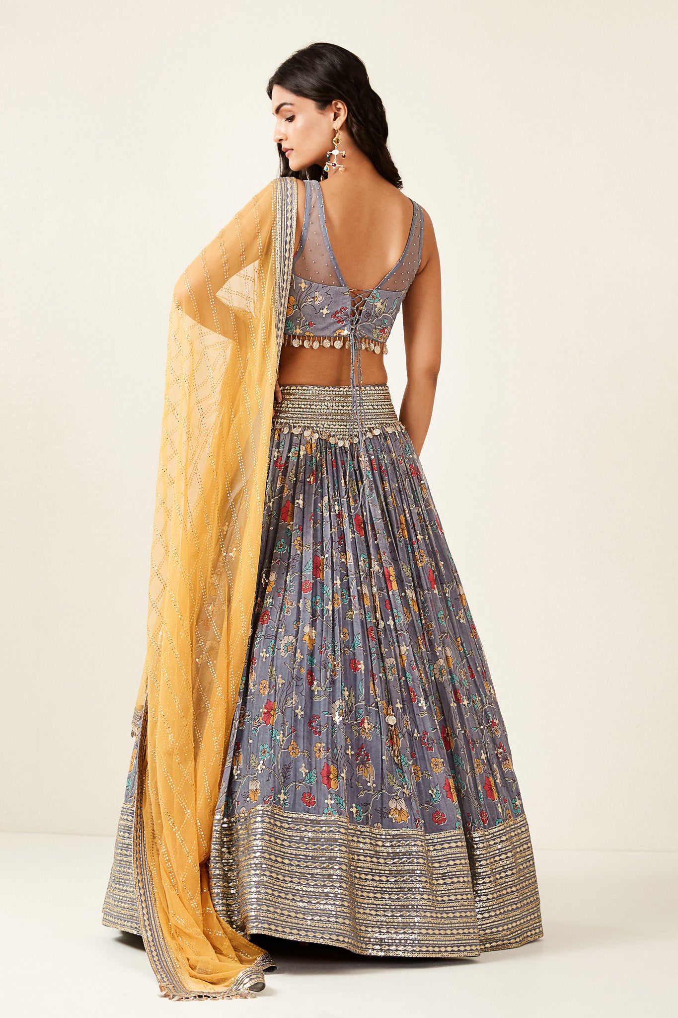 Shop look your best on wedding occasions in this beautiful grey color lehenga with hand embroidery, cut dana, and a beautiful blouse. Dazzle on weddings and special occasions with exquisite Indian designer dresses, sharara suits, Anarkali suits, bridal lehengas, and sharara suits from Pure Elegance Indian clothing store in the USA. Shop online from Pure Elegance.