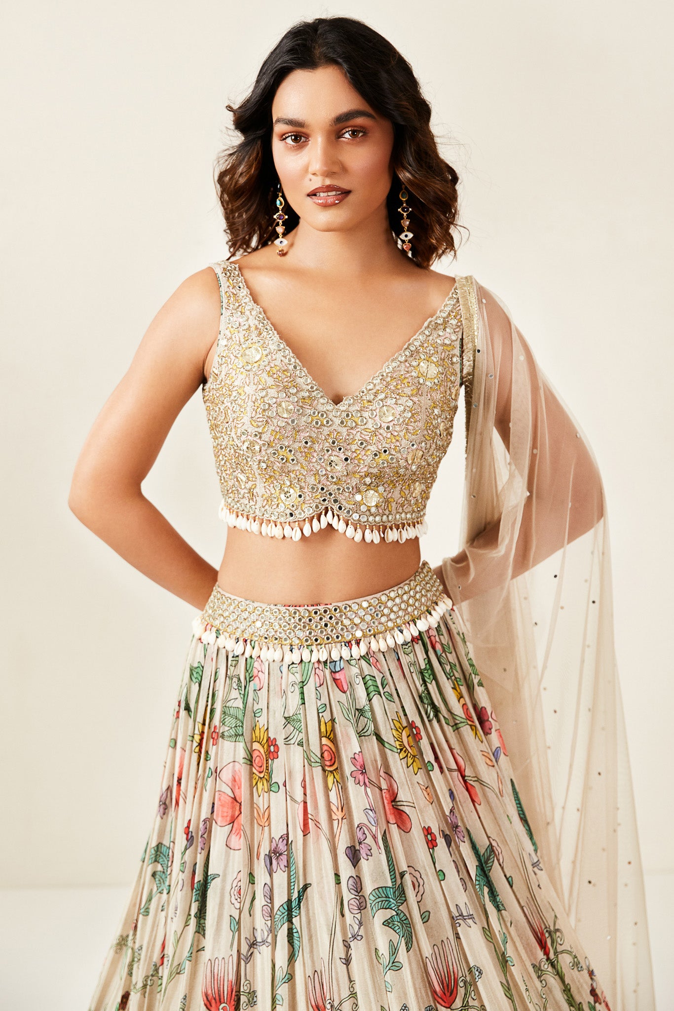 Shop look your best on wedding occasions in this beautiful grey color lehenga with mirror embroidery, cut dana, shells & coins detailing, and a beautiful blouse. Dazzle on weddings and special occasions with exquisite Indian designer dresses, sharara suits, Anarkali suits, bridal lehengas, and sharara suits from Pure Elegance Indian clothing store in the USA. Shop online from Pure Elegance.