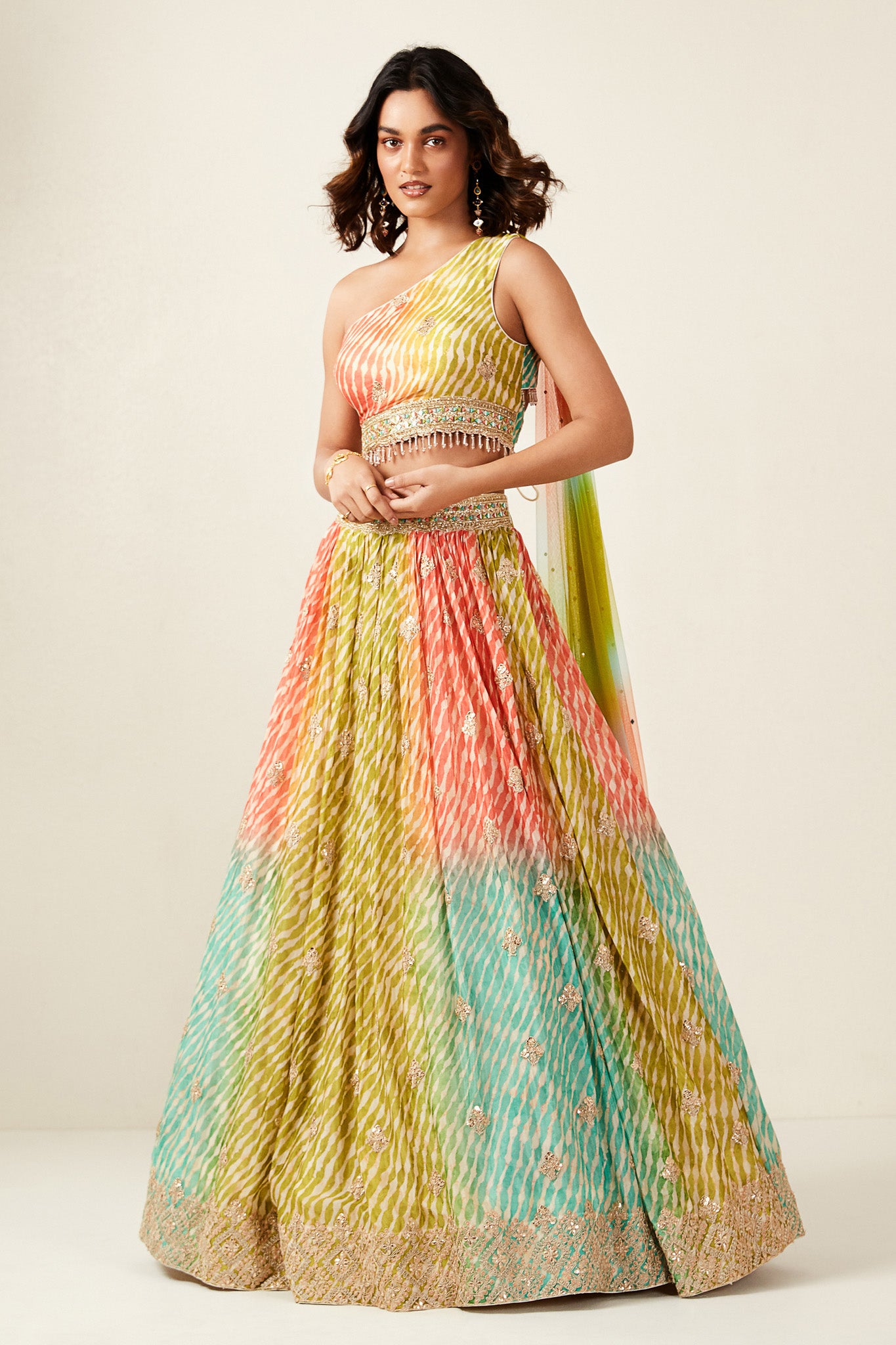 Shop look your best on wedding occasions in this beautiful multi color lehenga with resham and mirror embroidery, cut dana, and a beautiful blouse. Dazzle on weddings and special occasions with exquisite Indian designer dresses, sharara suits, Anarkali suits, bridal lehengas, and sharara suits from Pure Elegance Indian clothing store in the USA. Shop online from Pure Elegance.