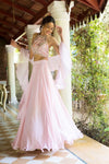 Buy beautiful powder pink halter neck lehenga online in USA with ruffle dupatta. Dazzle on weddings and special occasions with exquisite Indian designer dresses, sharara suits, Anarkali suits, wedding lehengas from Pure Elegance Indian fashion store in USA.-front
