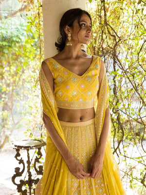 Buy beautiful sunny yellow Lucknowi work lehenga online in USA with dupatta. Dazzle on weddings and special occasions with exquisite Indian designer dresses, sharara suits, Anarkali suits, wedding lehengas from Pure Elegance Indian fashion store in USA.-closeup