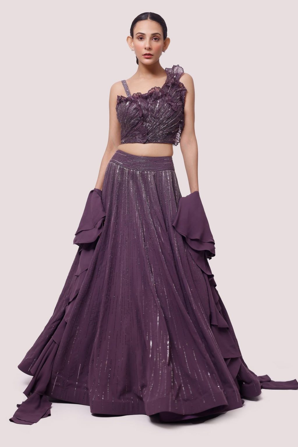 Buy a Beautiful purple georgette sleeveless lehenga featuring pearl, cut dana, and sequin work. The lehenga is perfect for weddings and sangeet parties. Shop online from Pure Elegance.