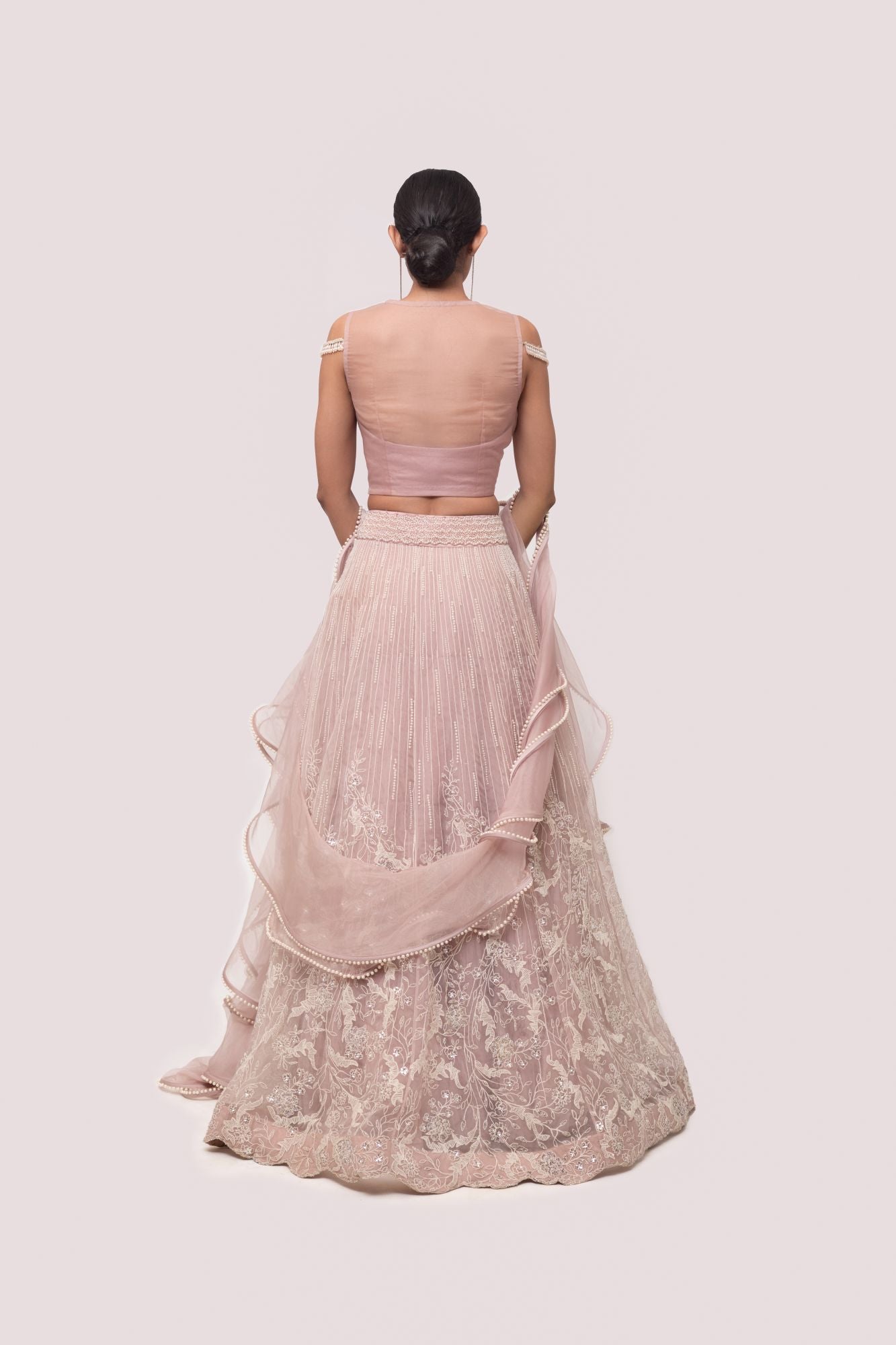 Buy a Beautiful pink floral short net sleeves lehenga featuring pearl and thread embroidery. The lehenga is perfect for weddings and sangeet parties. Shop online from Pure Elegance.