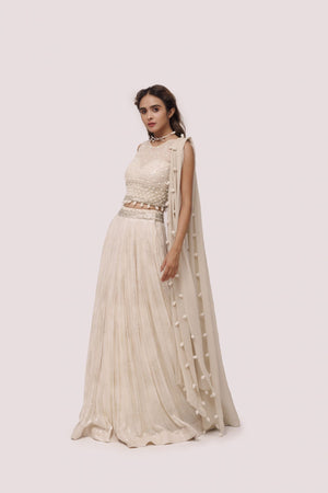 Shop the look your best on wedding occasions in this beautiful off-white color lehenga with pearl embroidery on the blouse and dupatta. Dazzle on weddings and special occasions with exquisite Indian designer dresses, sharara suits, Anarkali suits, bridal lehengas, and sharara suits from Pure Elegance Indian clothing store in the USA. Shop online from Pure Elegance.