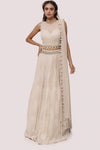 Shop the look your best on wedding occasions in this beautiful off-white color lehenga with pearl embroidery on the blouse and dupatta. Dazzle on weddings and special occasions with exquisite Indian designer dresses, sharara suits, Anarkali suits, bridal lehengas, and sharara suits from Pure Elegance Indian clothing store in the USA. Shop online from Pure Elegance.
