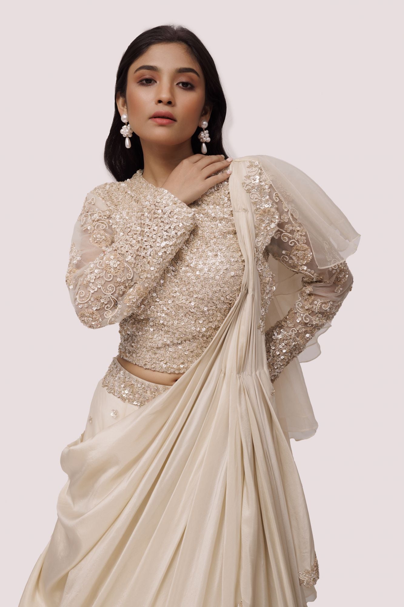 Shop the Look your best on wedding occasions in this beautiful off-white color lehenga with sequin embroidery on the blouse and a beautiful ruffle dupatta. Dazzle on weddings and special occasions with exquisite Indian designer dresses, sharara suits, Anarkali suits, bridal lehengas, and sharara suits from Pure Elegance Indian clothing store in the USA. Shop online from Pure Elegance.