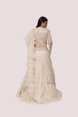 Shop the Look your best on wedding occasions in this beautiful off-white color lehenga with sequin embroidery on the blouse and a beautiful ruffle dupatta. Dazzle on weddings and special occasions with exquisite Indian designer dresses, sharara suits, Anarkali suits, bridal lehengas, and sharara suits from Pure Elegance Indian clothing store in the USA. Shop online from Pure Elegance.