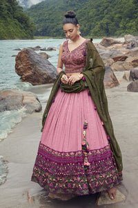 Shop an exquisite pink lehenga with a green dupatta. The lehenga is perfect for cocktail and sangeet parties. It is crafted in georgette with beautiful self-embroidery and a sleeveless blouse. Shop online from Pure Elegance.