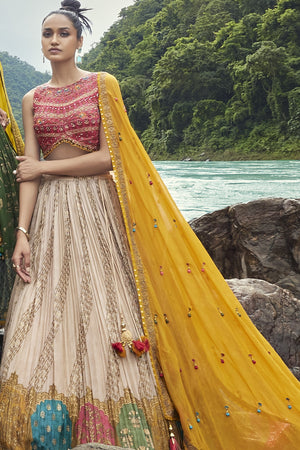 Shop this beautiful off-white lehenga with an embellished yellow dupatta. The lehenga is perfect for haldi parties. It is crafted with intricate embroidery work. Shop online from Pure Elegance.