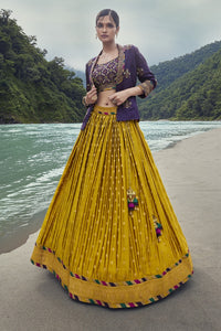 Shop this beautiful yellow lehenga with an embellished purple Jacket. The lehenga is perfect for haldi parties and sangeet ceremonies. It is crafted with intricate embroidery work. Shop online from Pure Elegance.