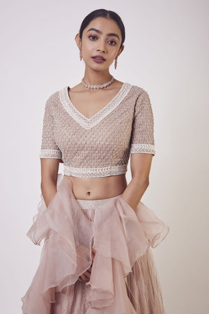 Shop stunning peach organza lehenga online in USA with ruffle dupatta. Get festive ready in beautiful designer Anarkali suits, designer lehenga, wedding gowns, sharara suits, designer sarees from Pure Elegance Indian fashion store in USA.-closeup