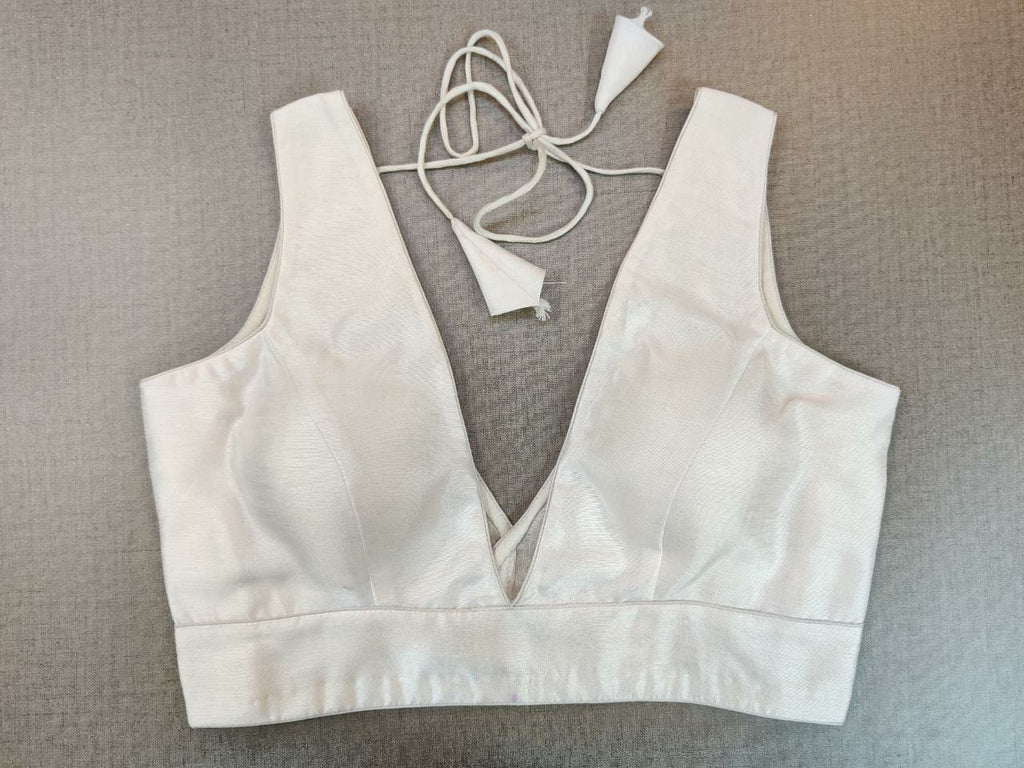 Buy stunning solid white sleeveless saree blouse online in USA with V-neckline. Elevate your Indian ethnic saree looks with beautiful readymade saree blouse, embroidered saree blouses, Banarasi saree blouse, designer sari blouses from Pure Elegance Indian fashion store in USA.-front