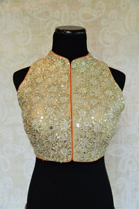 Shop this Indian designer sleeveless blouse from our store in USA or online from Pure Elegance. It is perfect for any wedding. High neck trendy Bollywood fashion. High Neck Blouse.