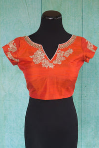 Buy this orange floral designer blouse perfect for any wedding party or reception from Pure Elegance or our store in USA. Deep neck short sleeved Bollywood fashion. Front View.
