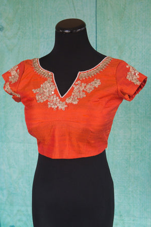 Buy this orange floral designer blouse perfect for any wedding party or reception from Pure Elegance or our store in USA. Deep neck short sleeved Bollywood fashion. Floral Print.