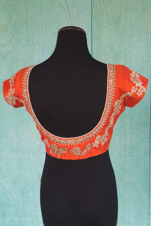 Buy this orange floral designer blouse perfect for any wedding party or reception from Pure Elegance or our store in USA. Deep neck short sleeved Bollywood fashion. Deep Back.