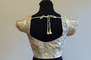 Buy this Indian designer silk blouse with gold embroidery online or at our Pure Elegance store in Edison. Semi sleeved saree blouse is Ideal for any sangeet party. Sexy Back.