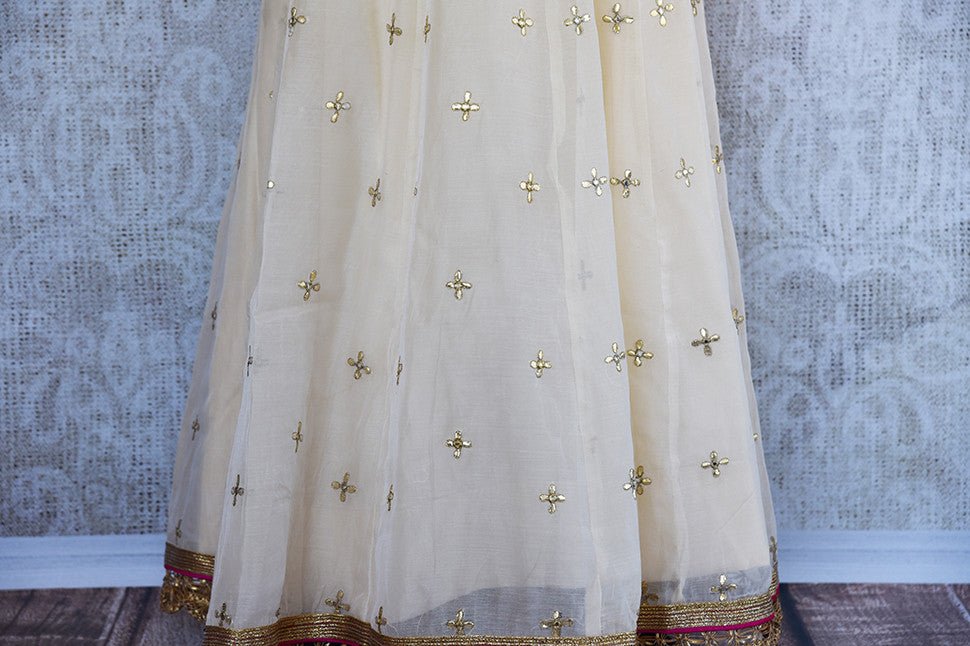  Designer white anarkali with embroidery all over the bodice and hem. Perfect suit in Parties.- Ghera