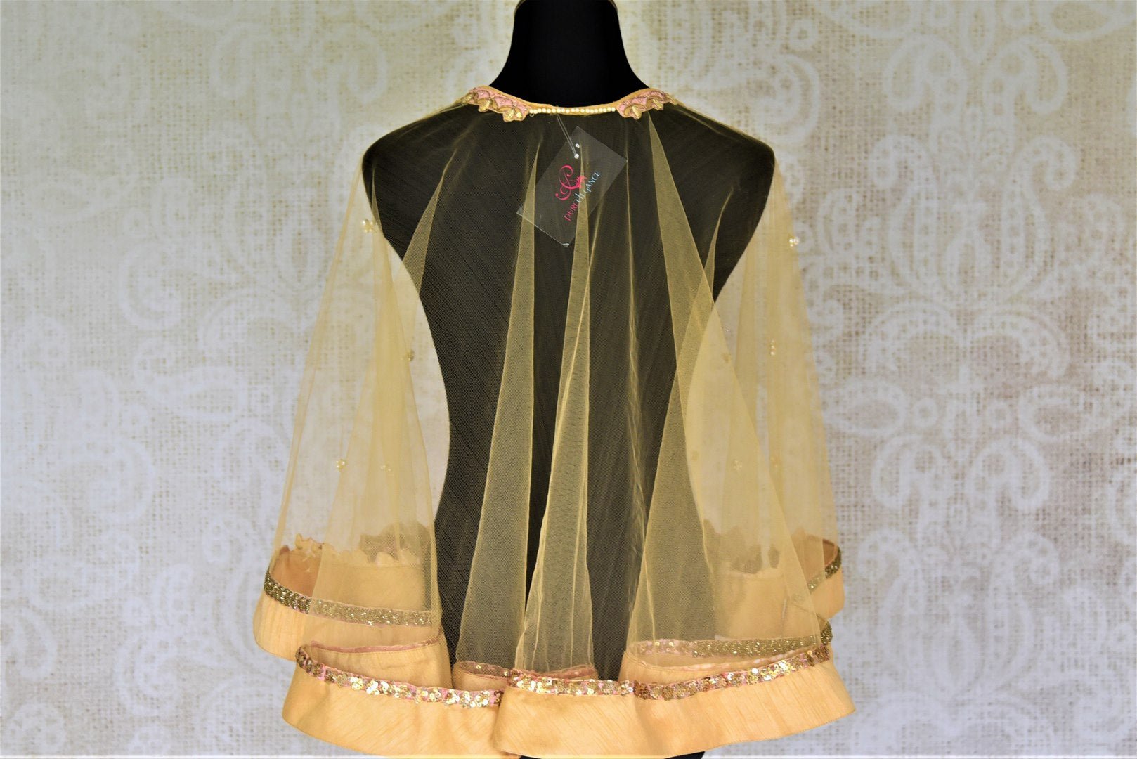 Shop cream hand embroidered net designer cape blouse online in USA. Complete your ethnic saree look with designer blouses, readymade sari blouse, embroidered saree blouse from Pure Elegance Indian saree store in USA.-back