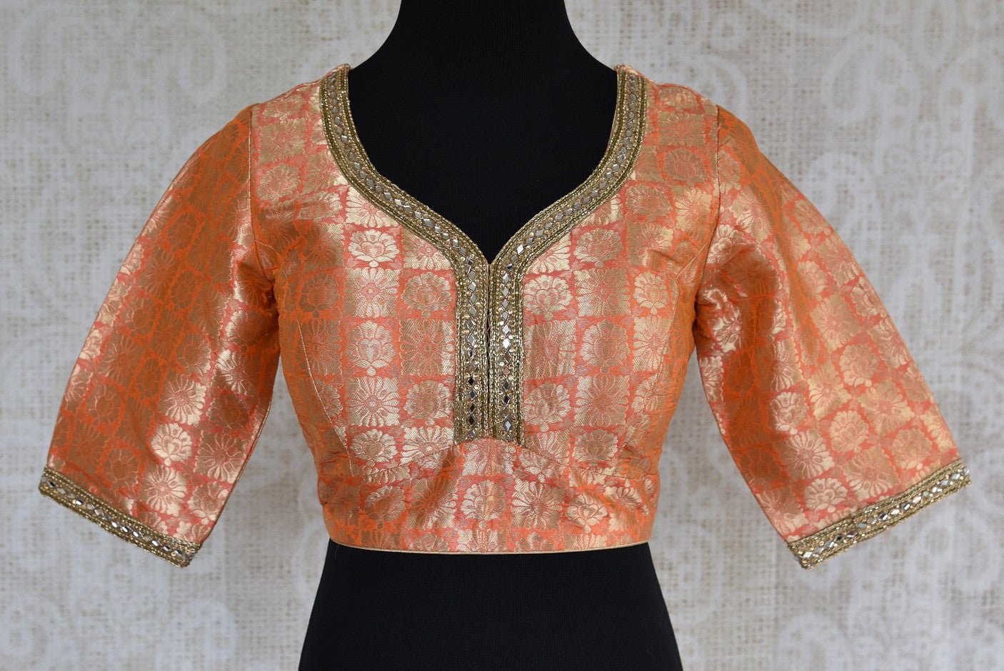 Shop this Indian ethnic orange blouse having stone work on neck and sleeves online or from our store in USA. It is perfect for any engagement or wedding party. Orange Blouse.