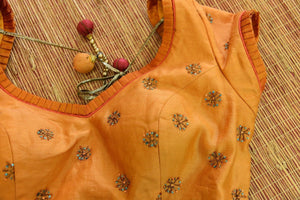 Shop this ethnic designer orange chanderi blouse Pure Elegance online or from our store in USA. Bollywood style blouse perfect for any pooja or dandiya night. Close up.