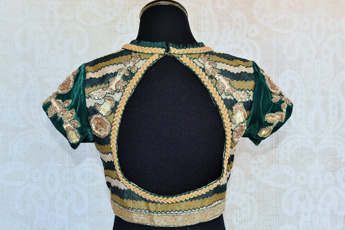 Shop this Indian traditional green embroidered velvet designer blouse online and from  Pure Elegance store in USA. Perfect for any wedding or reception party. Cut Out.