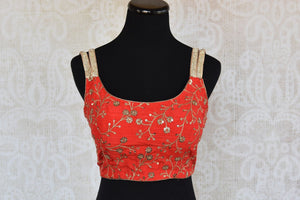 Buy this Indian traditional red sleeveless deep neck designer blouse perfect for any sangeet party or reception from Pure Elegance online or at our store in USA. Front View.