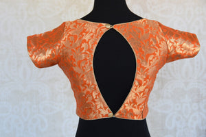 Buy this orange semi-sleeved ethnic pre-stitched designer crop top blouse perfect for any wedding or pooja from Pure Elegance online or from our store near NYC. Back Slit.