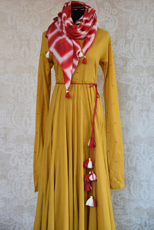 Buy this malmal cotton mustard yellow anarkali dress online or from our store in USA. The Indian outfit with a French knot is ideal for any wedding or reception. Close up.