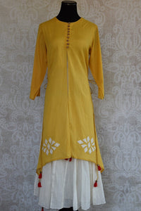 Buy this mustard Indo western yellow and white Indian ethnic dress online from our Pure Elegance store in USA. It is perfect for any wedding or reception party. Front View.