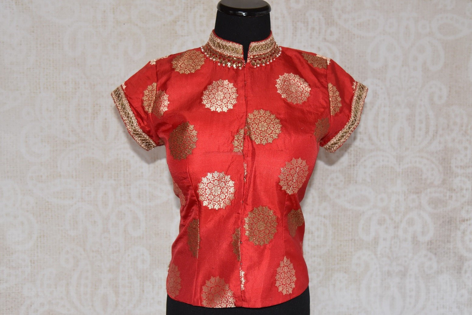 Shop this traditional Indian orange high neck embroidered blouse from Pure Elegance online or from our store in USA. Perfect for any wedding or reception party. Front View.