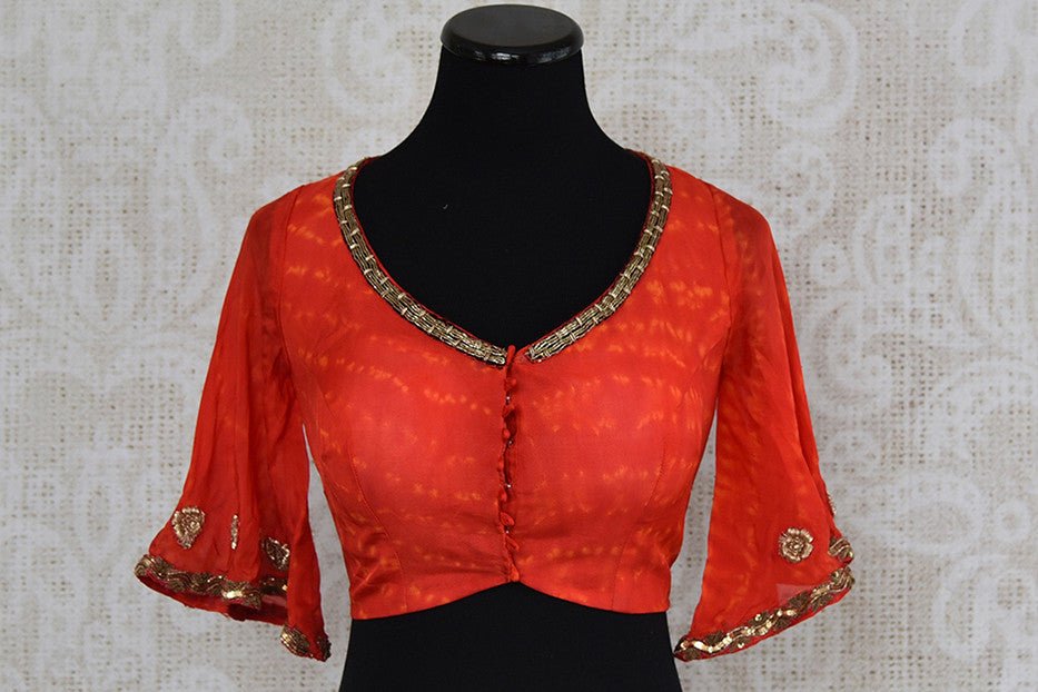 Orange embroidered v neck blouse. Pair this blouse with any saree o skirt and get a trendy look.- front