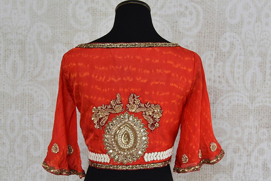Orange embroidered v neck blouse. Pair this blouse with any saree o skirt and get a trendy look.-back