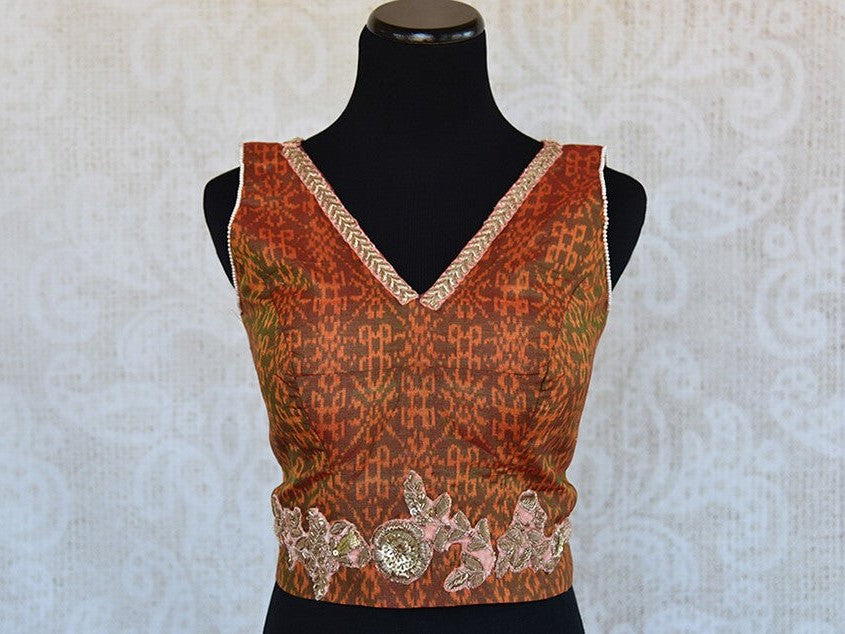 Orange ikkat printed pre-stitched blouse with zari embroidery V-neck blouse. Pair with solid saree and skirt.-front