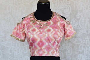 Pink printed cotton silk cold shoulder blouse with embroidery on neck and sleeves and net detailing on back.-front