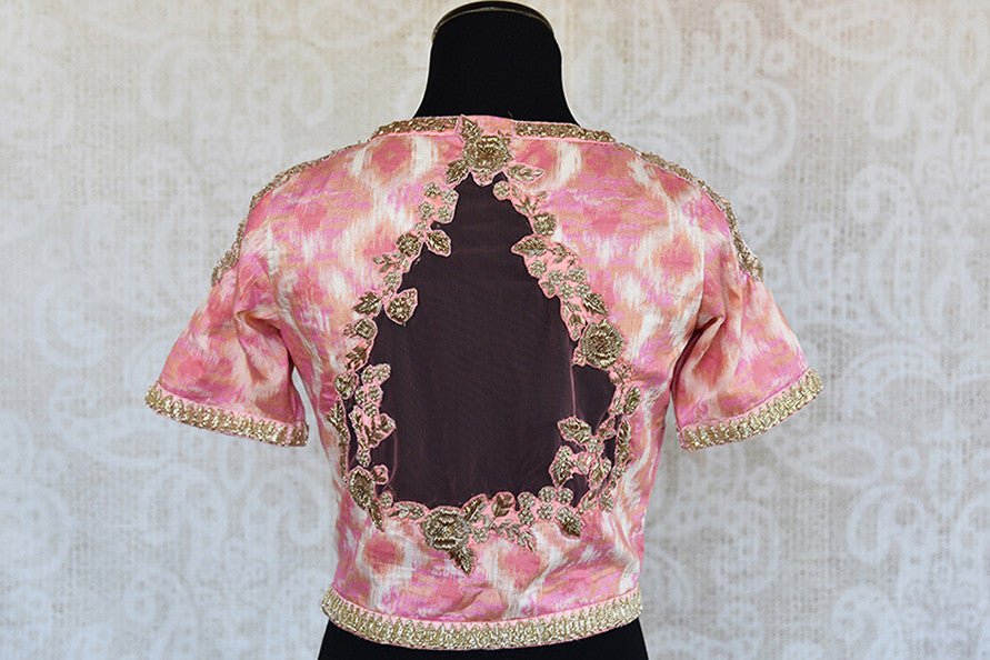 Pink printed cotton silk cold shoulder blouse with embroidery on neck and sleeves and net detailing on back.-back
