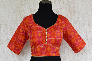 Orange silk ikkat blouse in choli design. Pair this traditional blouse with any saree or lahenga. -front