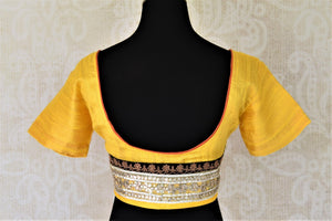 Buy gorgeous yellow silk saree blouse online in USA with gota patti work back. Complete your ethnic saree look with designer blouses, readymade sari blouse, embroidered saree blouse from Pure Elegance Indian saree store in USA.-back