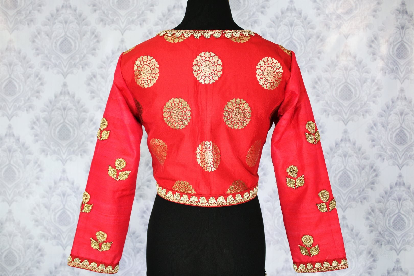 Buy ethnic red embroidered Banarasi saree blouse online in USA. Pure Elegance Indian clothing store brings an exquisite range of readymade saree blouses in USA to match your gorgeous Indian sarees. Elevate your ethnic look with stylish Indian sari blouses for weddings and parties.-back