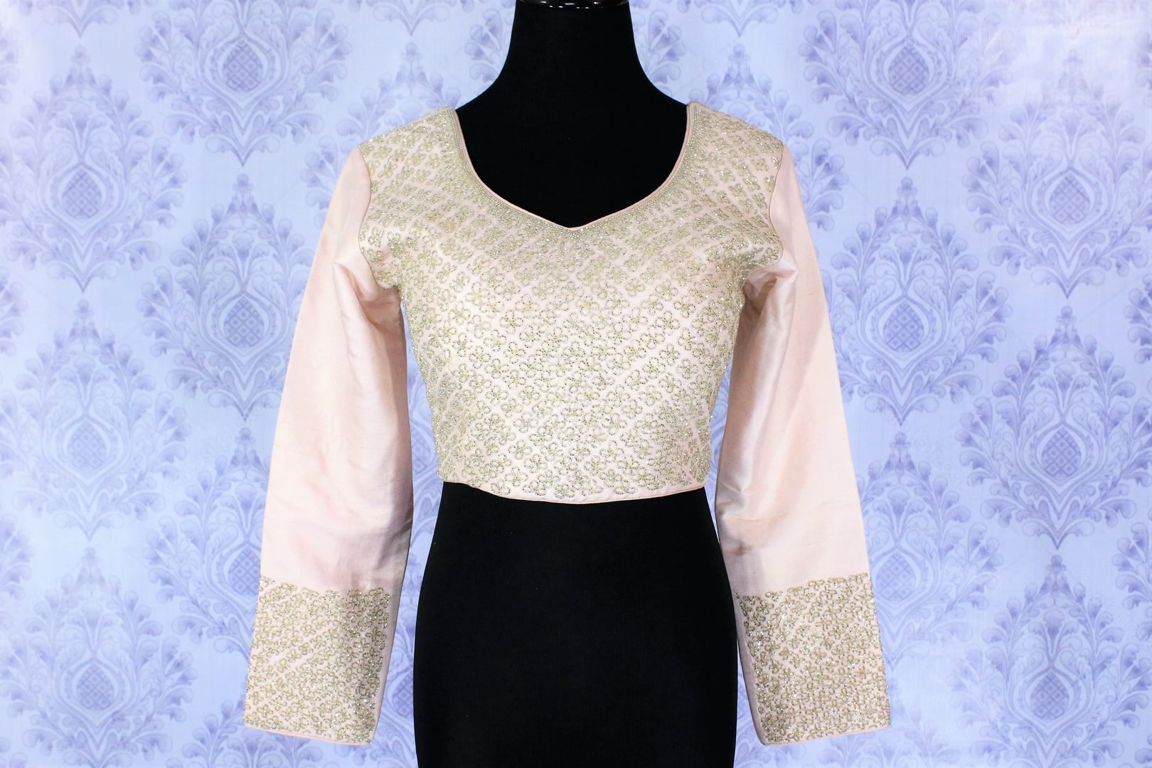 Be a pastel popper in this pretty blush pink embroidered designer blouse. The intricate details all over the blouse complemented with beautiful dramatic flannel sleeves totally elevate the saree game. Shop beautifully handcrafted sari blouses online or visit Pure Elegance store in USA.-front